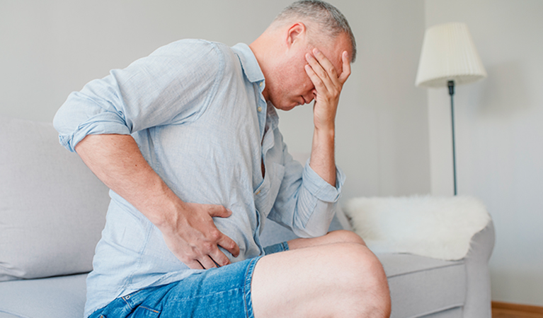 Man stomach suffering from stomachache or Gastroenterologist. Concept with Healthcare And Medicine. Unhappy man suffering from stomach ache at home
